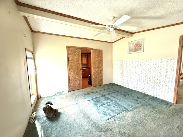 unfurnished room with a ceiling fan, crown molding, carpet floors, a textured ceiling, and lofted ceiling