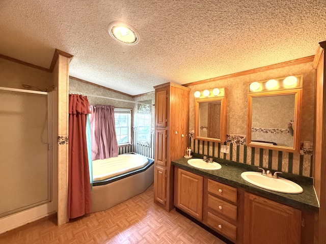 bathroom featuring crown molding, a stall shower, a textured ceiling, double vanity, and lofted ceiling