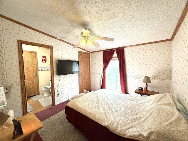bedroom with crown molding, wallpapered walls, ensuite bathroom, and a ceiling fan