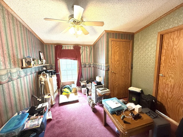 recreation room with ornamental molding, wallpapered walls, a ceiling fan, a textured ceiling, and carpet