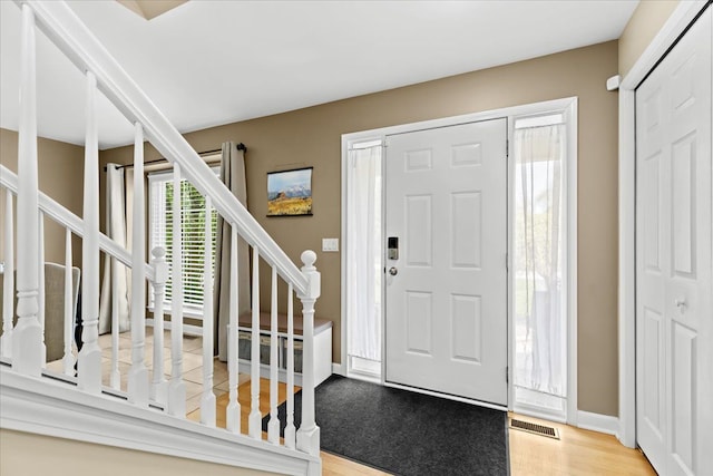 3645 Sandbar Dr, Commerce Twp, MI 48382 - foyer with stairs, wood finished floors, and baseboards