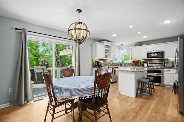 3645 Sandbar Dr, Commerce Twp, MI 48382 - dining space with a chandelier, light wood-style flooring, and recessed lighting