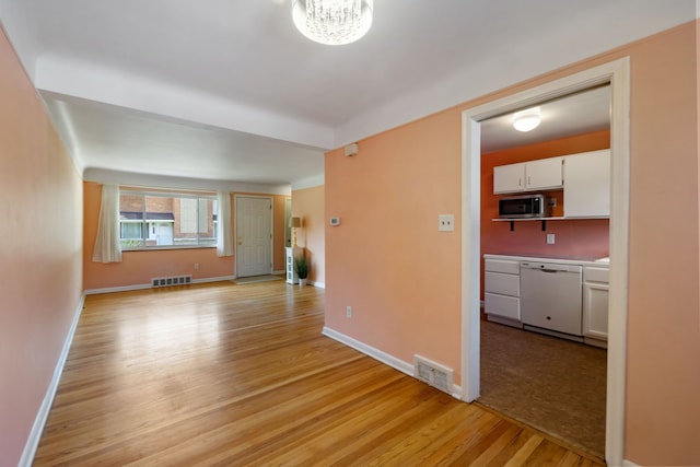 9917 Middlebelt Rd, Livonia, MI 48150 - unfurnished room featuring light wood-style flooring, a chandelier, and baseboards