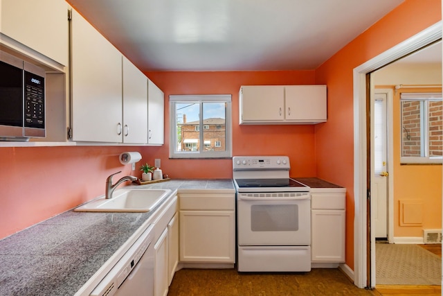 9917 Middlebelt Rd, Livonia, MI 48150 - kitchen with white appliances, a sink, white cabinetry, and tile countertops