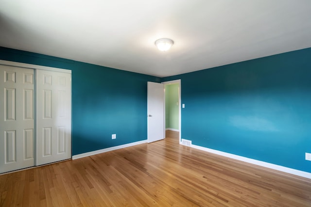 9917 Middlebelt Rd, Livonia, MI 48150 - unfurnished bedroom featuring baseboards, light wood-type flooring, and a closet