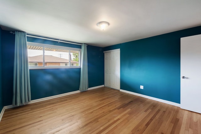 9917 Middlebelt Rd, Livonia, MI 48150 - unfurnished bedroom featuring wood finished floors, baseboards, and a closet