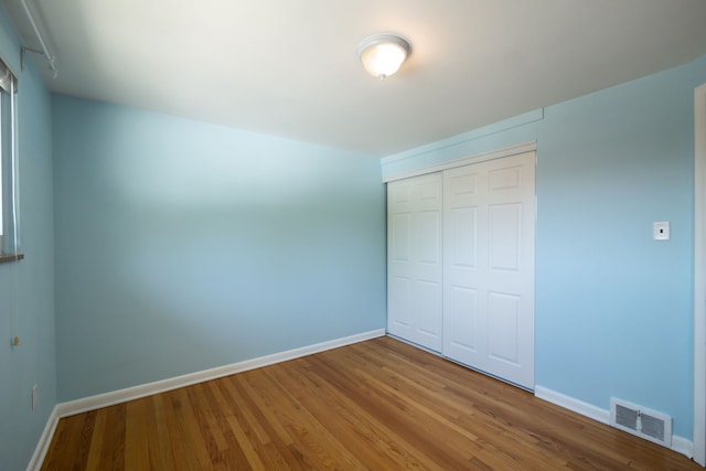 9917 Middlebelt Rd, Livonia, MI 48150 - unfurnished bedroom with baseboards, a closet, and wood finished floors