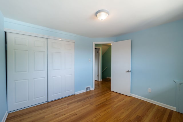 9917 Middlebelt Rd, Livonia, MI 48150 - unfurnished bedroom with light wood finished floors, a closet, and baseboards