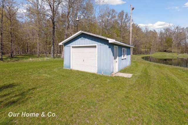 view of outbuilding with an outdoor structure, a view of trees, and a water view