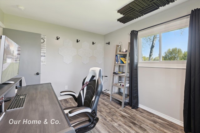 office space with wood finished floors and baseboards