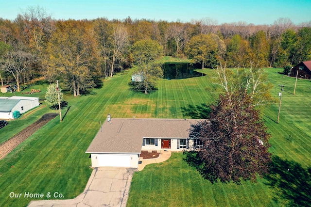 aerial view of property and surrounding area with a heavily wooded area