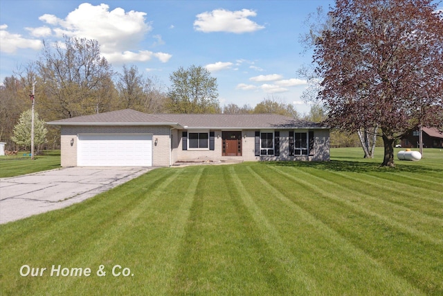 ranch-style house featuring a garage, a front yard, concrete driveway, and brick siding