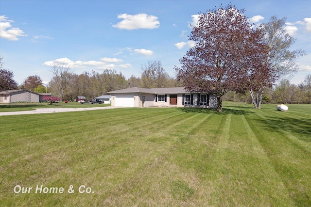 view of front facade with a garage, concrete driveway, and a front lawn