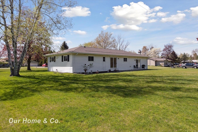 back of property with a yard