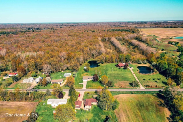 aerial view of property's location featuring a forest