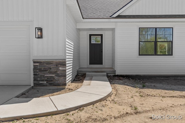 property entrance with roof with shingles, board and batten siding, and stone siding