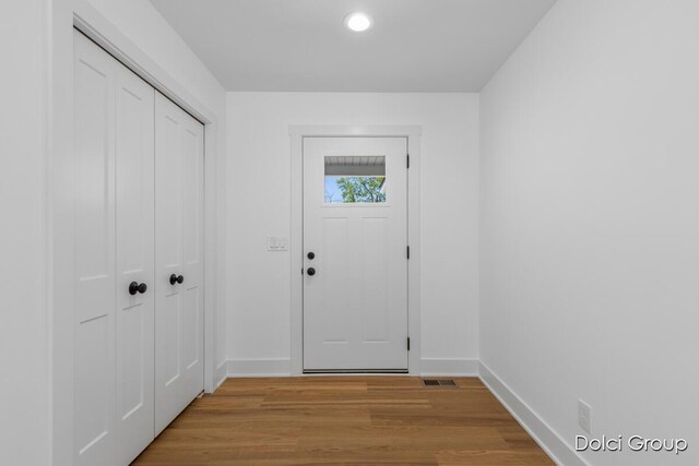 entryway featuring baseboards, light wood-style flooring, and recessed lighting