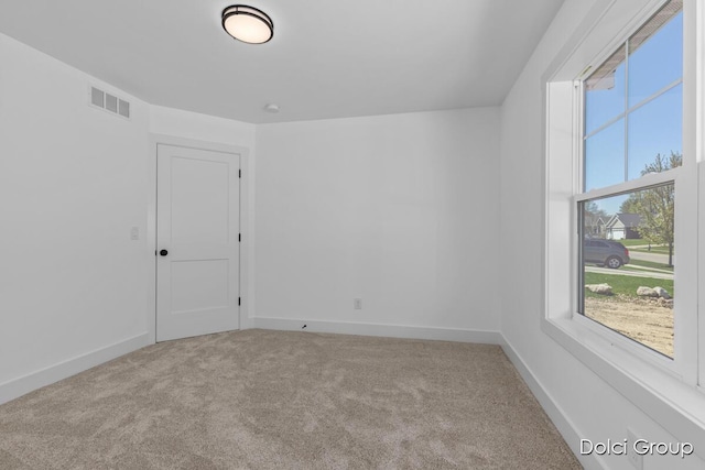 carpeted spare room with baseboards