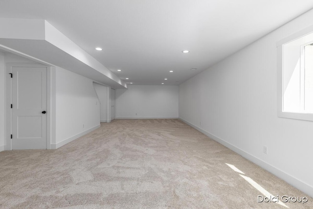 additional living space featuring light carpet, recessed lighting, and baseboards