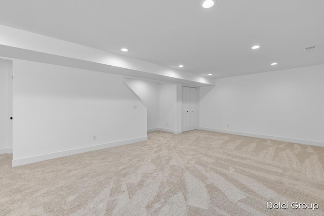 finished below grade area with light carpet, recessed lighting, and baseboards
