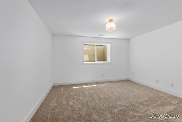 empty room with carpet flooring and baseboards