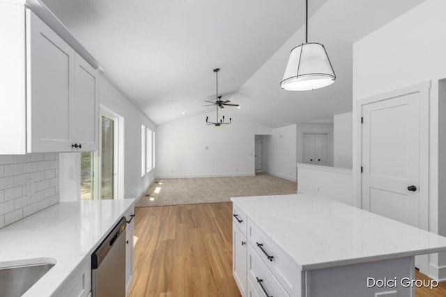kitchen with dishwasher, vaulted ceiling, ceiling fan, light wood-style floors, and tasteful backsplash