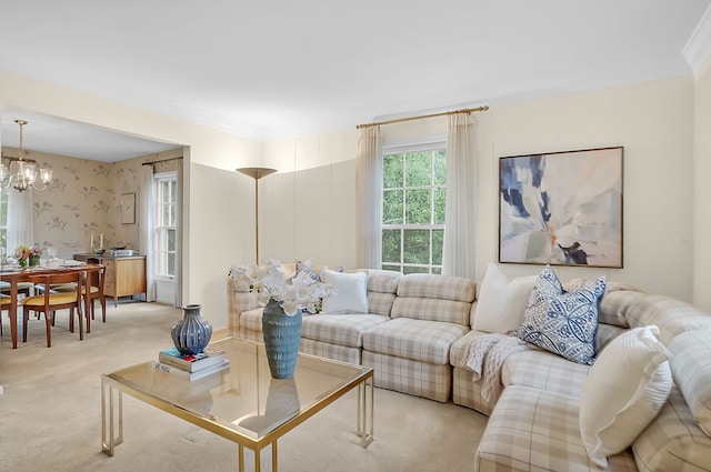 living room featuring light carpet, a chandelier, and ornamental molding