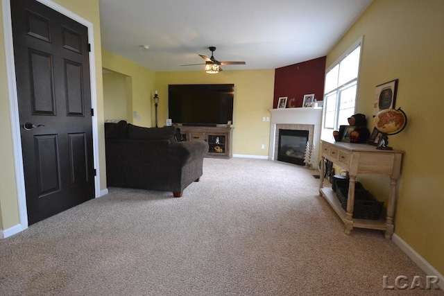 1872 Allan St, Adrian, MI 49221 - living area with a tiled fireplace, a ceiling fan, light colored carpet, and baseboards