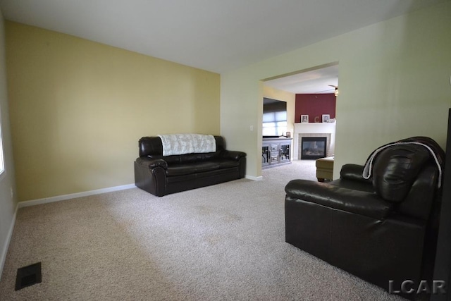 1872 Allan St, Adrian, MI 49221 - carpeted living room with a tile fireplace and baseboards