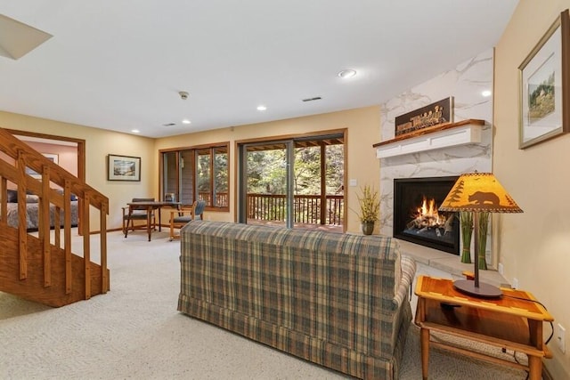10059 Weko Dr, Bridgman, MI 49106 - carpeted living room featuring a premium fireplace, stairs, and recessed lighting