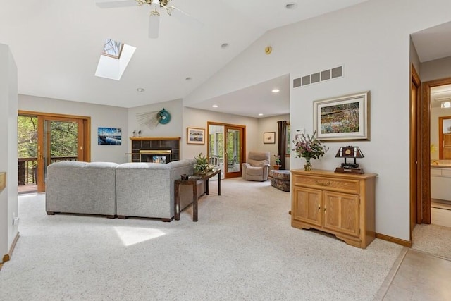 10059 Weko Dr, Bridgman, MI 49106 - living room with a ceiling fan, lofted ceiling, a skylight, light colored carpet, and a tiled fireplace