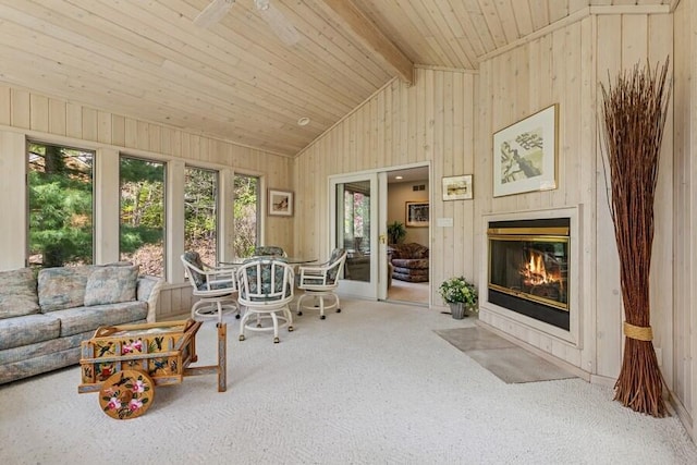 10059 Weko Dr, Bridgman, MI 49106 - carpeted living area featuring wooden walls, a fireplace with flush hearth, and wood ceiling