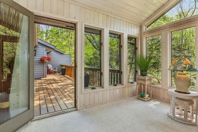 10059 Weko Dr, Bridgman, MI 49106 - sunroom featuring lofted ceiling, wooden walls, a deck, and carpet flooring