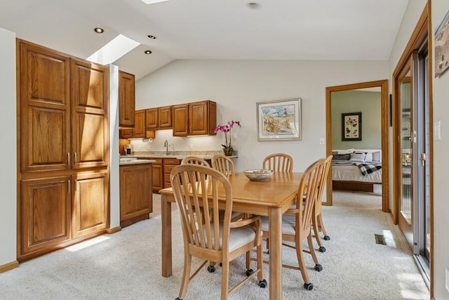 10059 Weko Dr, Bridgman, MI 49106 - dining space featuring lofted ceiling, a skylight, and light carpet
