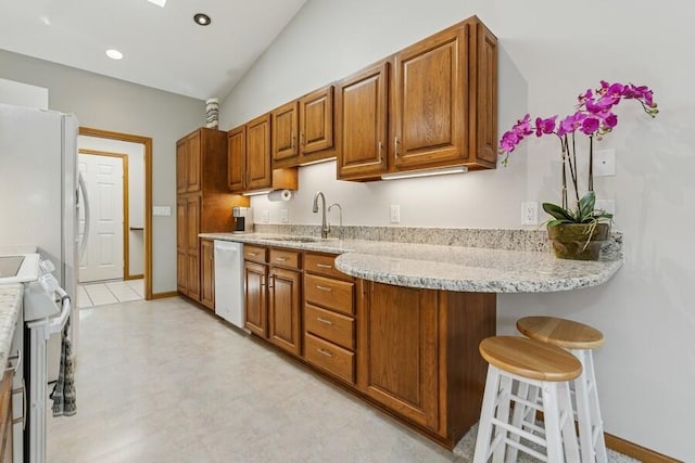 10059 Weko Dr, Bridgman, MI 49106 - kitchen featuring white appliances, a sink, and brown cabinets