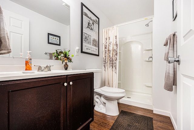 754 Autumn Valley Dr, Ortonville, MI 48462 - full bath featuring toilet, wood finished floors, vanity, curtained shower, and baseboards