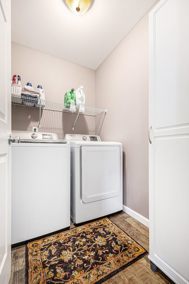 754 Autumn Valley Dr, Ortonville, MI 48462 - laundry area featuring washer and clothes dryer, wood finished floors, and baseboards