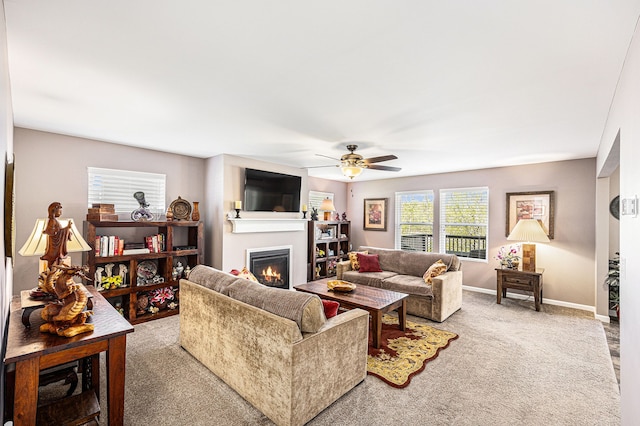 754 Autumn Valley Dr, Ortonville, MI 48462 - carpeted living area with a lit fireplace, ceiling fan, and baseboards