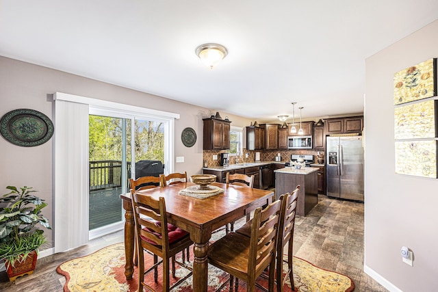 754 Autumn Valley Dr, Ortonville, MI 48462 - dining area with wood finished floors and baseboards