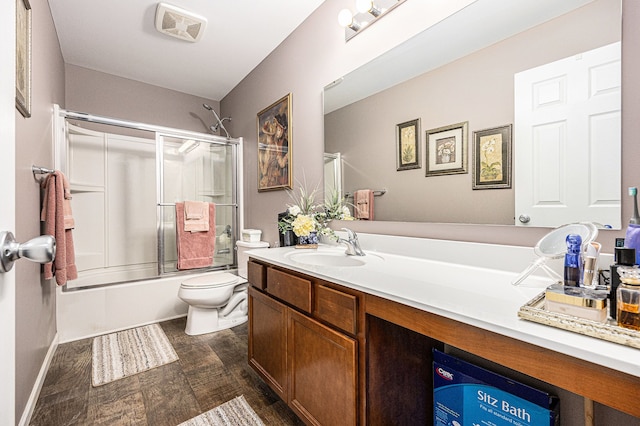 754 Autumn Valley Dr, Ortonville, MI 48462 - full bath featuring vanity, toilet, enclosed tub / shower combo, and wood finished floors