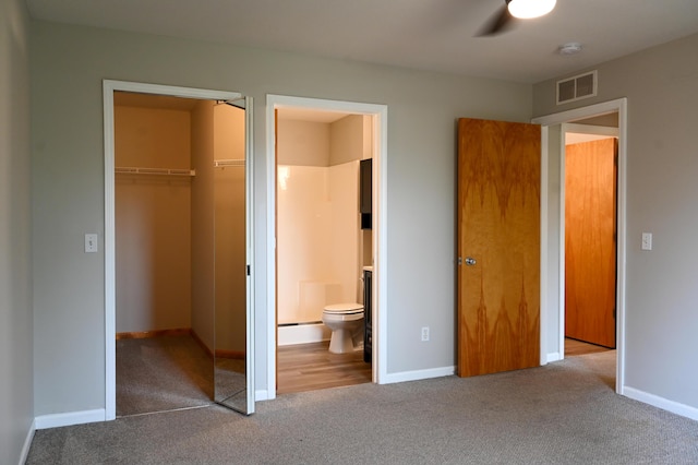 45762 Prairiegrass Ct Unit 7, Michigan, MI 48111 - unfurnished bedroom featuring carpet flooring, a closet, connected bathroom, baseboards, and a baseboard heating unit