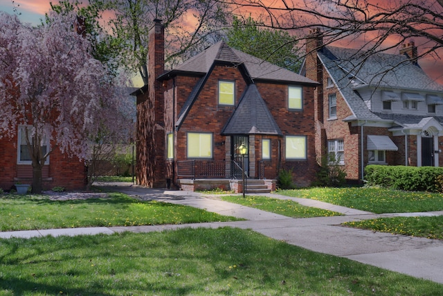 14643 Penrod St, Detroit, MI 48223 - english style home with a chimney, a lawn, brick siding, and a shingled roof