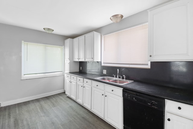 14643 Penrod St, Detroit, MI 48223 - kitchen featuring black dishwasher, a sink, dark countertops, light wood finished floors, and white cabinetry