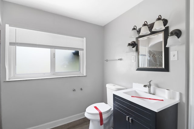 14643 Penrod St, Detroit, MI 48223 - bathroom featuring toilet, wood finished floors, vanity, and baseboards