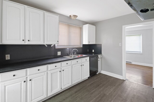 14643 Penrod St, Detroit, MI 48223 - kitchen featuring dishwasher, a sink, dark countertops, dark wood-style flooring, and white cabinets