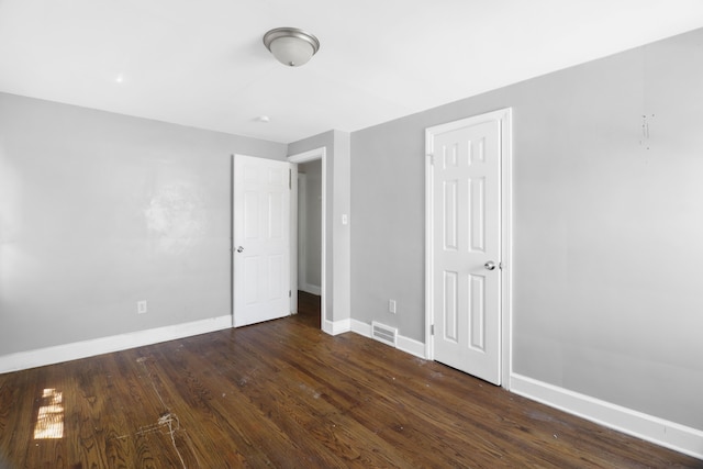14643 Penrod St, Detroit, MI 48223 - unfurnished bedroom featuring baseboards and dark wood finished floors