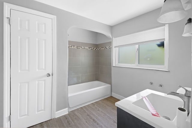 14643 Penrod St, Detroit, MI 48223 - bathroom with wood finished floors, baseboards, a bathtub, vanity, and a shower