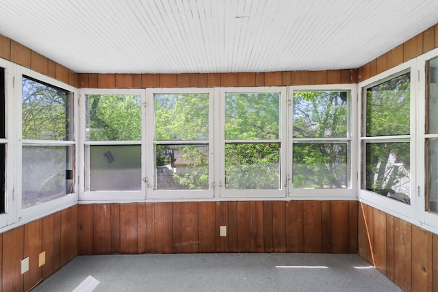14643 Penrod St, Detroit, MI 48223 - unfurnished sunroom featuring carpet flooring and wood walls