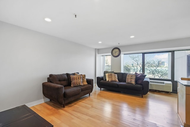 300 Riverfront Dr Unit 300/4C, Detroit, MI 48226 - living area featuring light wood-style floors, recessed lighting, an AC wall unit, and baseboards