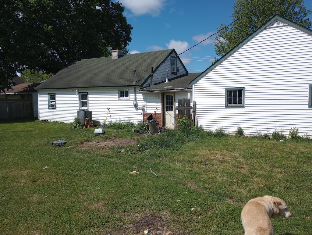 212 Grant St, Galien, MI 49113 - back of property featuring central air condition unit and a shingled roof